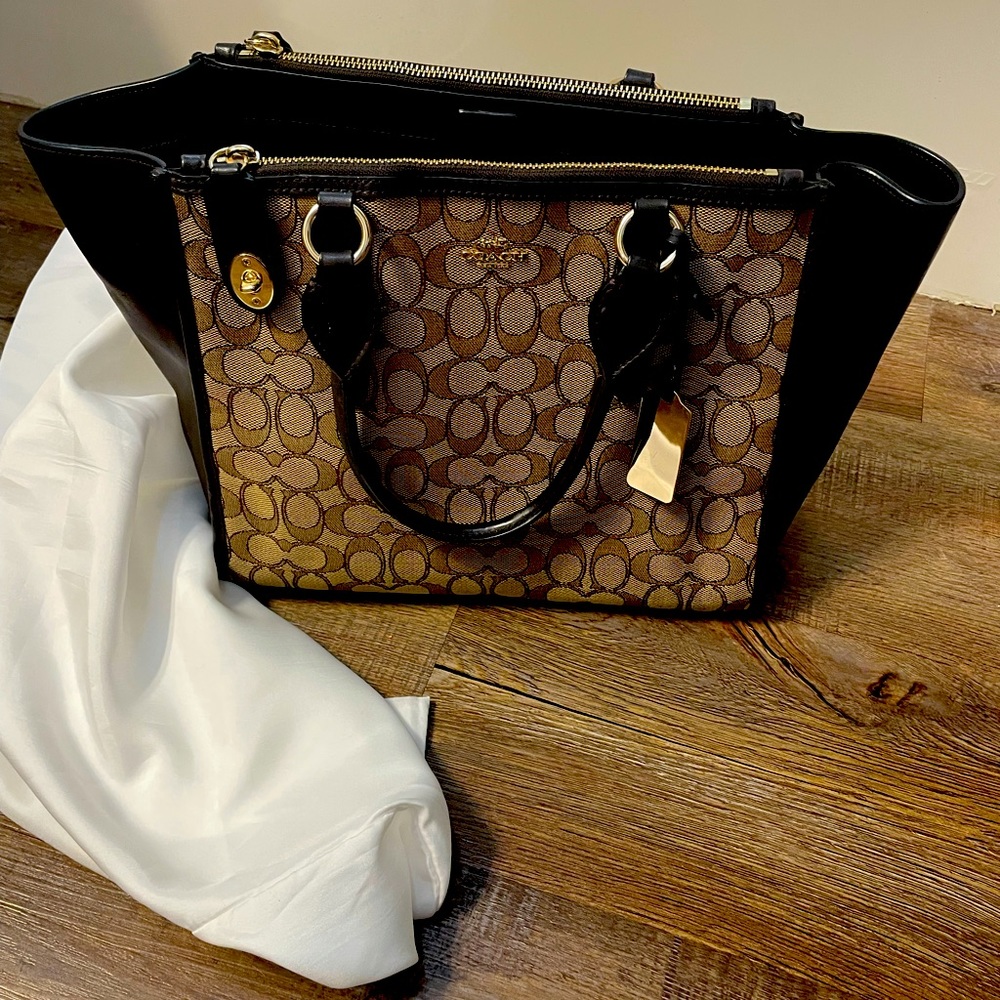 Coach handbag with Coach C insignia.